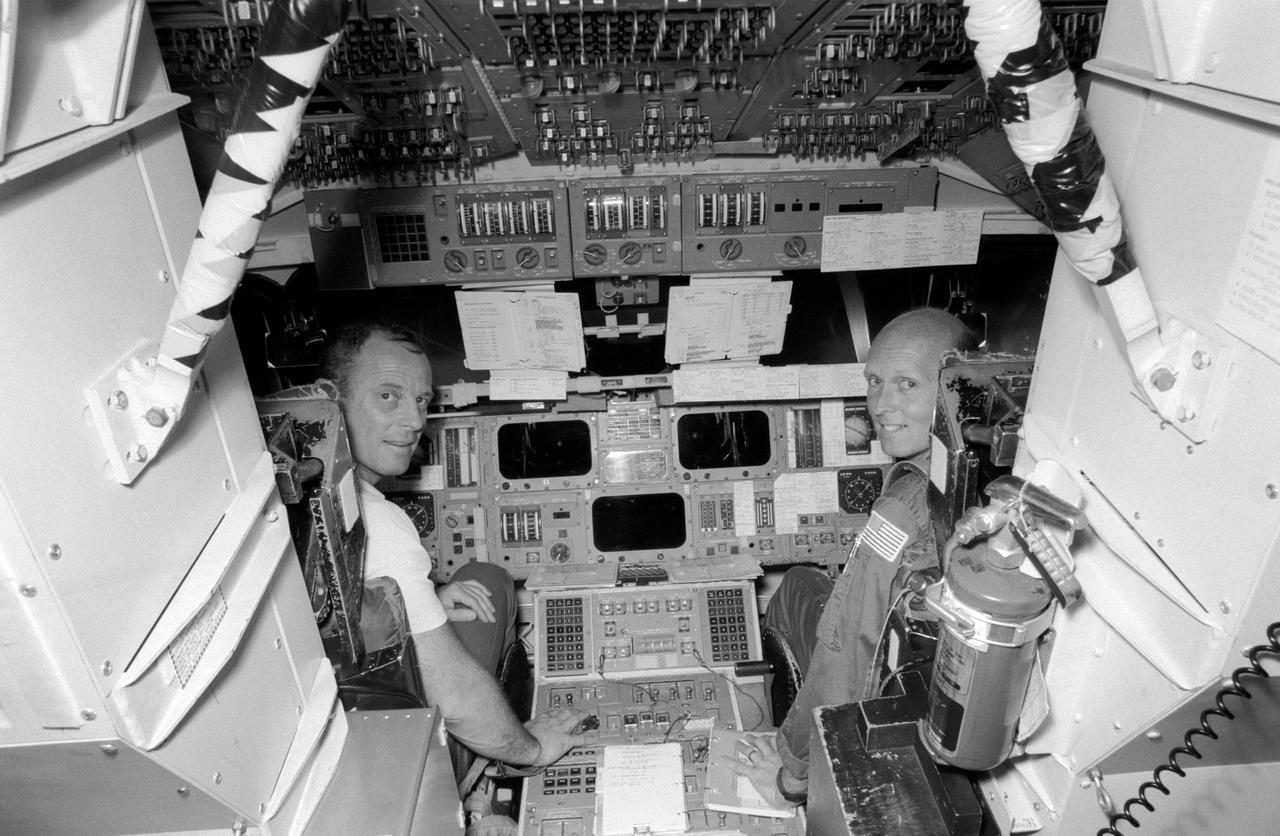 S82-28534 (16 March 1982) --- Astronauts Jack R. Lousma, left, and C. Gordon Fullerton are at the commander and pilot?s station, respectively, in the shuttle mission simulator at the LBJ Space Centers mission simulation and training facility. They have less than a week of training left in preparation for NASA?s third space transportation system (STS-3) flight. Scheduled to launch on March 22, STS-3 in expected to give space shuttle Columbia its longest stay (seven days) thus far. Photo credit: NASA