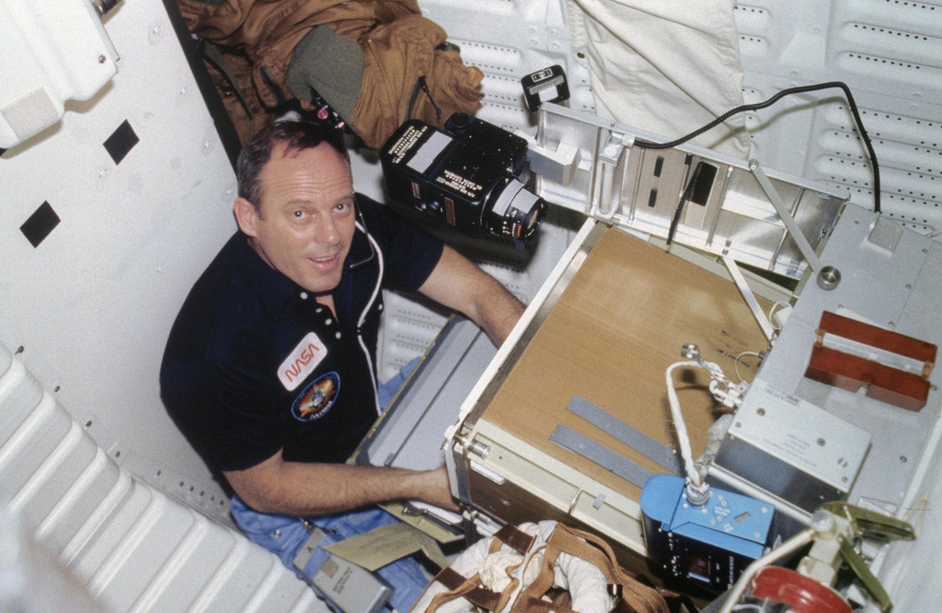 Jack Lousma works with an experiment on the STS-3 mission