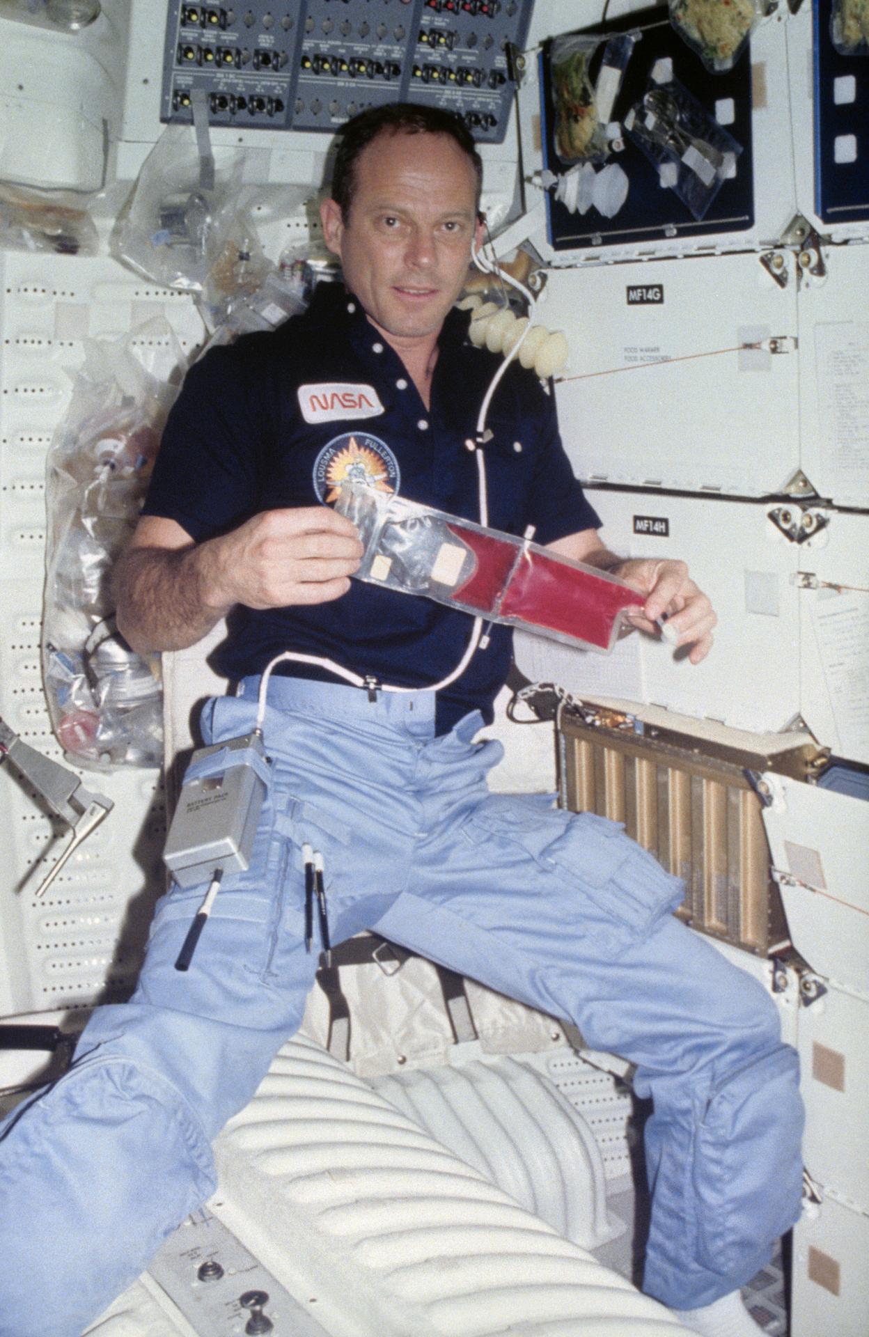 Jack Lousma with experiment in hand during STS-3
