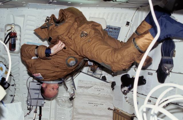 NASA image: Pilot Fullerton dons anti-g and ejection escape suit (EES) on middeck