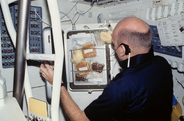 NASA image: Pilot Fullerton prepares meal on middeck