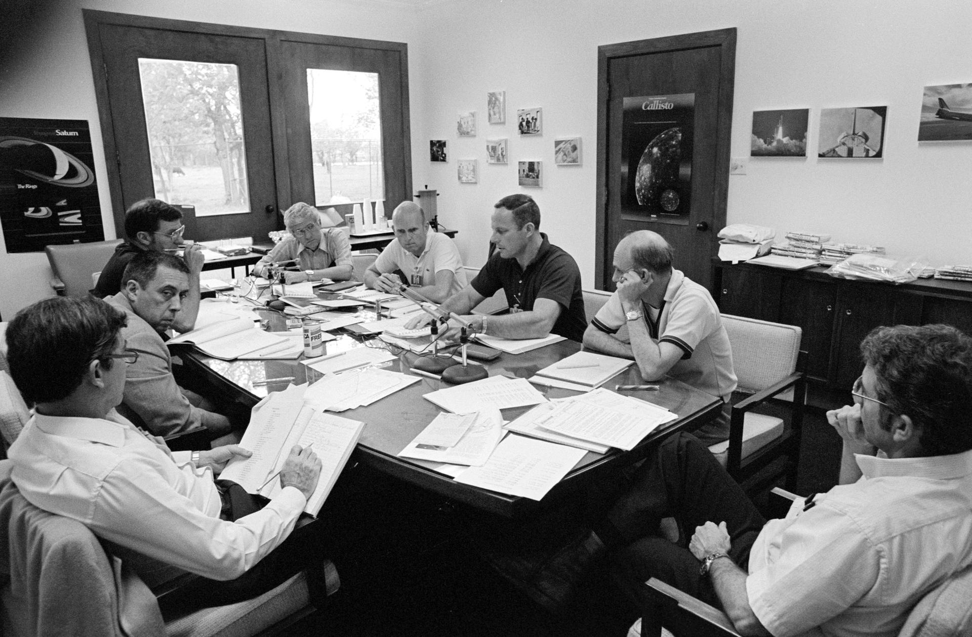 The crew for STS-2, STS-3, and STS-4 meet together for a debriefing