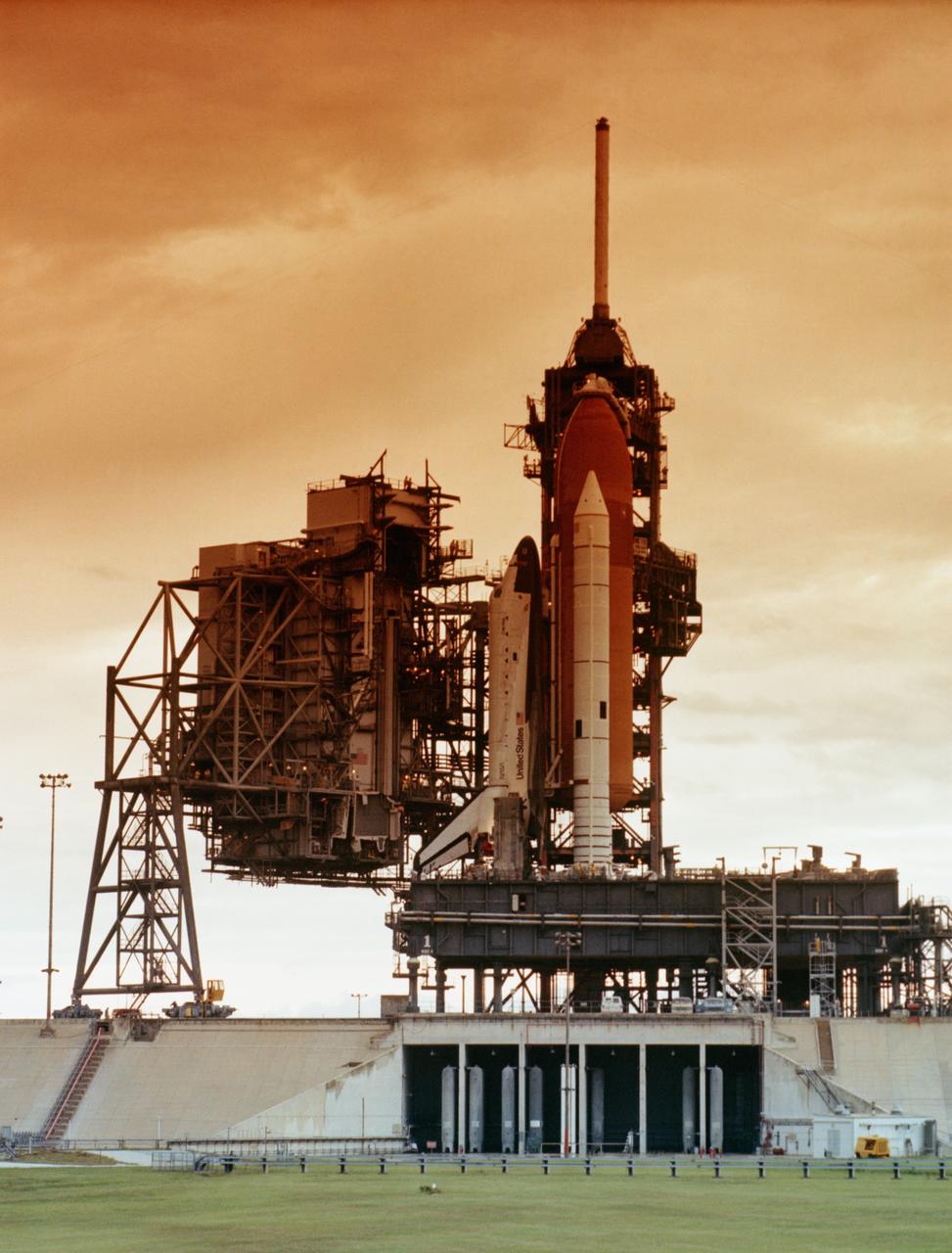 S82-32169 (26 May 1982) --- View of the space shuttle Columbia sitting on Launch Pad 39A at Kennedy Space Center (KSC), following rollout for STS-4, as preparations continue toward a late June launch. The fourth liftoff of the Columbia will mark the beginning of the final test flight in the Space Transportation System (STS) program. Astronauts Thomas K. Mattingly II and Henry W. Hartsfield will man the vehicle for a scheduled eight-day flight. Photo credit: NASA