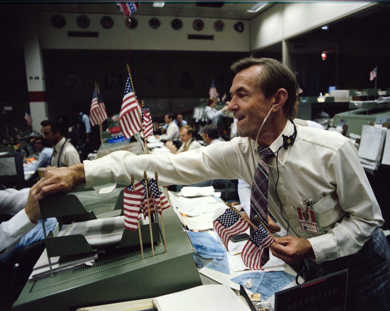 S82-33221 (4 July 1982) --- Lead STS-4 flight director Charles Lewis is congratulated by an unidentified flight controller (partially out of frame) in the Johnson Space Center's Mission Control Center following the landing of the space shuttle Columbia at Edwards Air Force Base in California. Photo credit: NASA