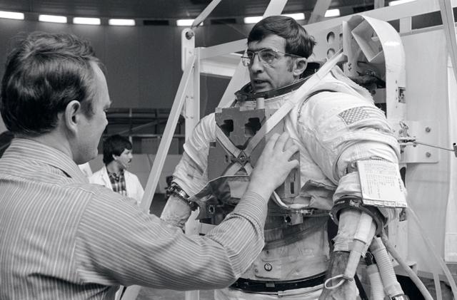 NASA image: Astronaut Bobko assists Astronaut Peterson prior to underwater training