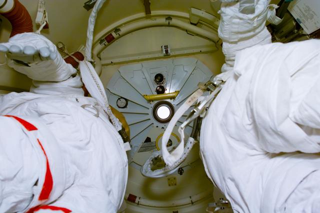 NASA image: Documentation of the external airlock interior with unstowed EMU suits