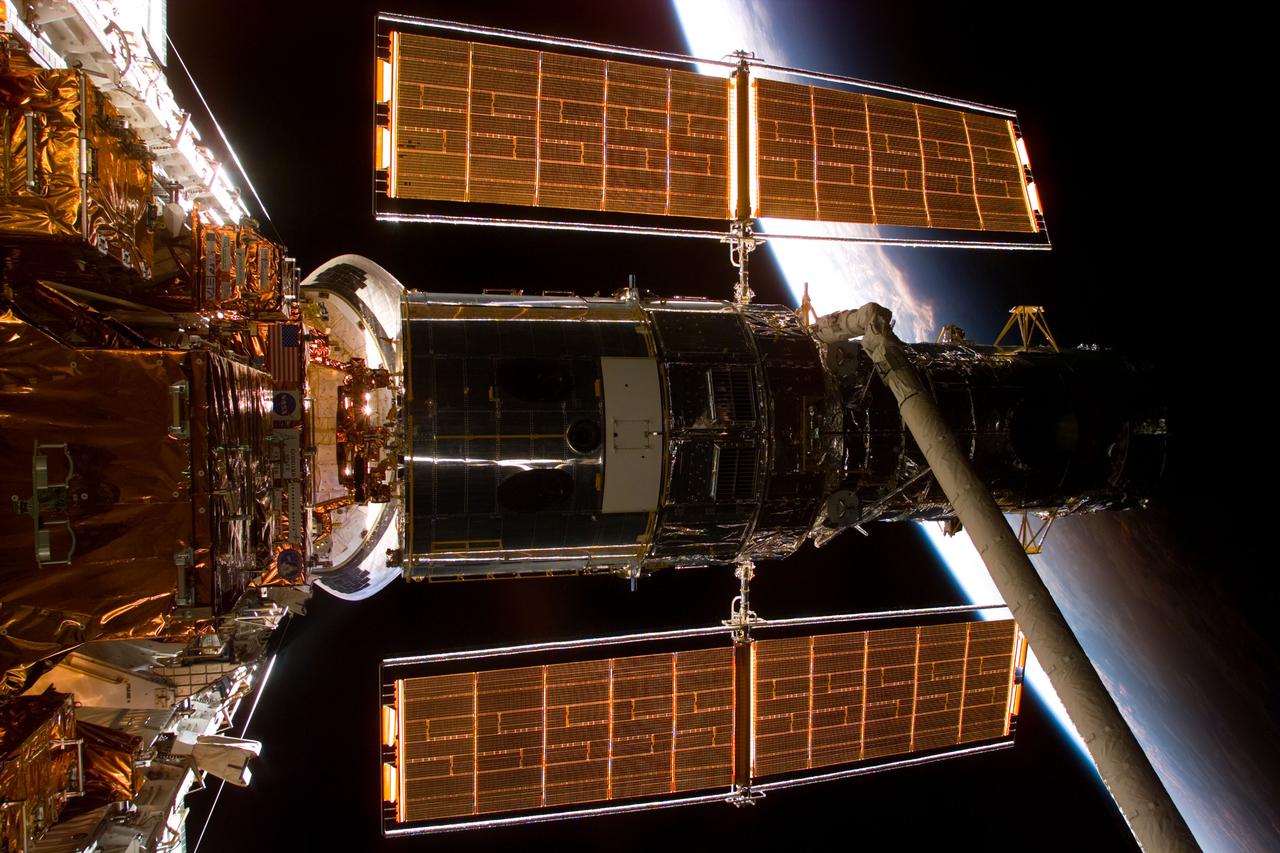 S82-E-5140 (13 Feb. 1997) --- A back-lighted full view of the Hubble Space Telescope (HST) in the grasp of the Remote Manipulation System (RMS) following capture early today.  The limb of Earth forms part of the background. This view was taken with an Electronic Still Camera (ESC).