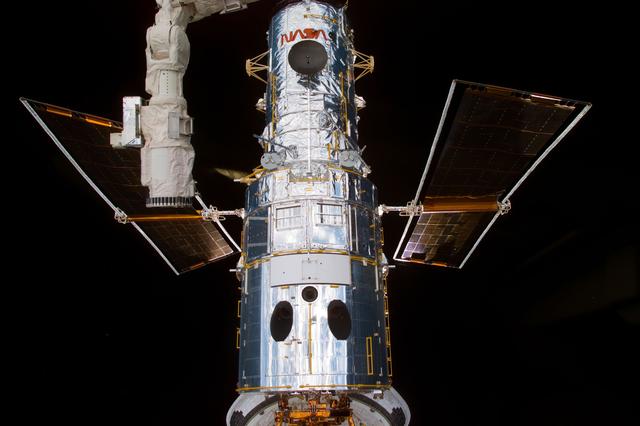 NASA image: HST,survey views of telescope after berthing