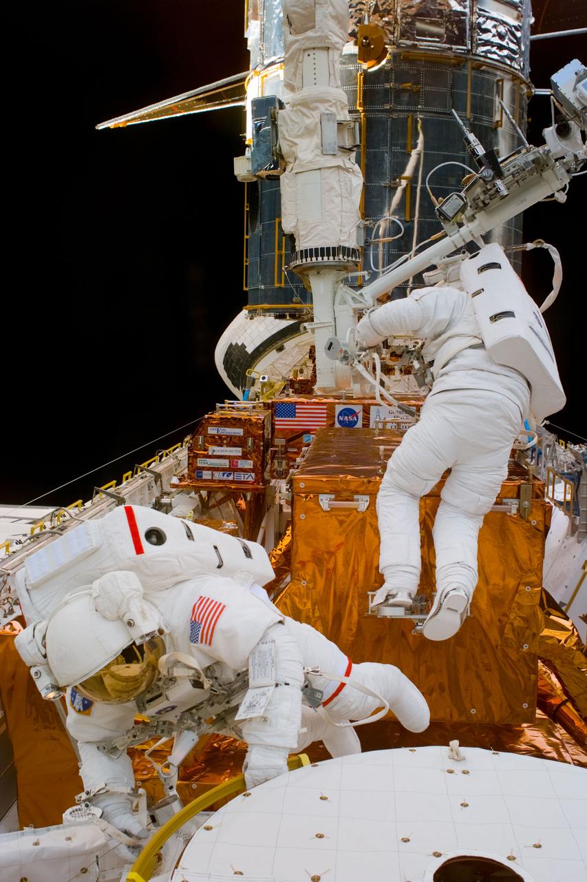 S82-E-5279 (14 Feb. 1997) --- Astronaut Mark C. Lee, STS-82 payload commander (in foreground) and Steven L. Smith during Extravehicular Activity (EVA) setup.  This view was taken with an Electronic Still Camera (ESC).