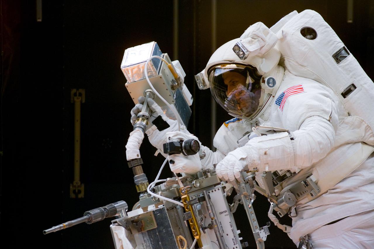 S82-E-5320 (14 Feb. 1997) --- Astronaut Steven L. Smith, STS-82 mission specialist, works with close-out camera in the Space Shuttle Discovery's payload bay.  This view was taken with an Electronic Still Camera (ESC).