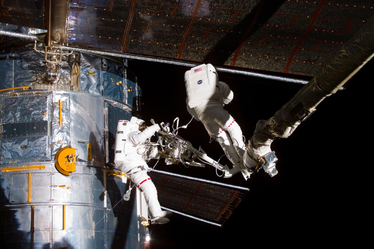 S82-E-5422 (15 Feb. 1997) --- Astronauts Gregory J. Harbaugh (left) and Joseph R. Tanner (right) during Mobile Foot Restraint (MFR) exchange. This view was taken with an Electronic Still Camera (ESC).