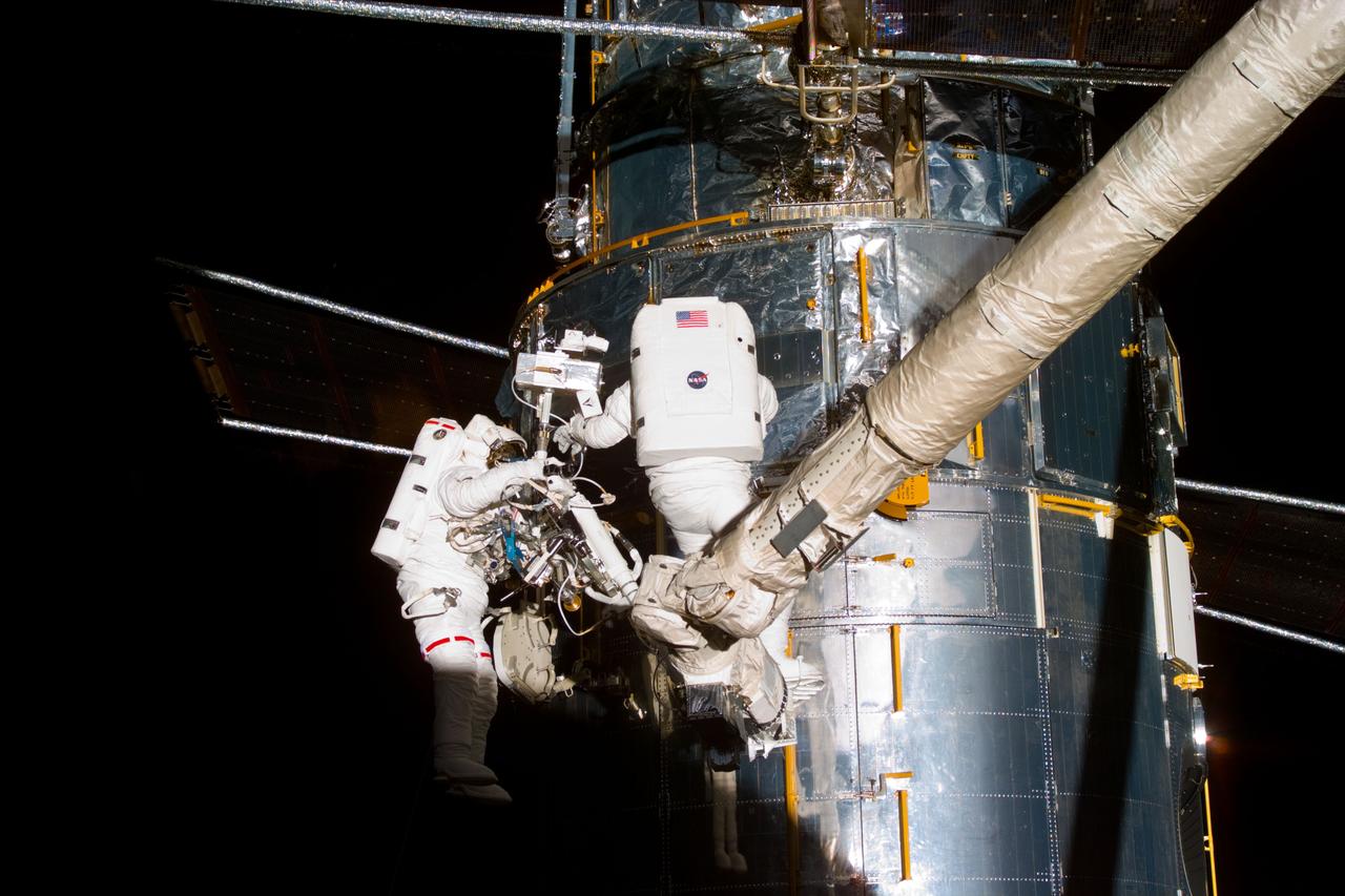 S82-E-5429 (15 Feb. 1997) --- Astronauts Gregory J. Harbaugh (left) and Joseph R. Tanner (right) during Multi Layer Insulation (MLI) inspection in Bay 10.  This view was taken with an Electronic Still Camera (ESC).