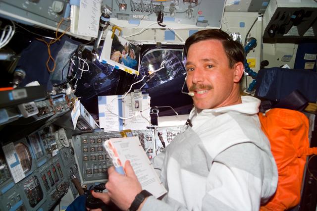 NASA image: Pilot Scott Horowitz consults a checklist during a Vernier burn
