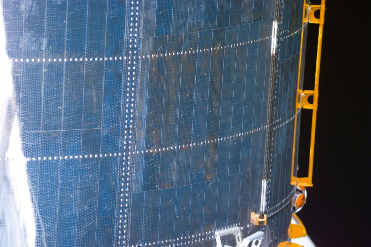 S82-E-5471 (15 Feb. 1997) --- Close-up view showing a small section of Hubble Space Telescope's (HST) protective covering and hand rail used to support Extravehicular Activity (EVA). This view was taken with an Electronic Still Camera (ESC).