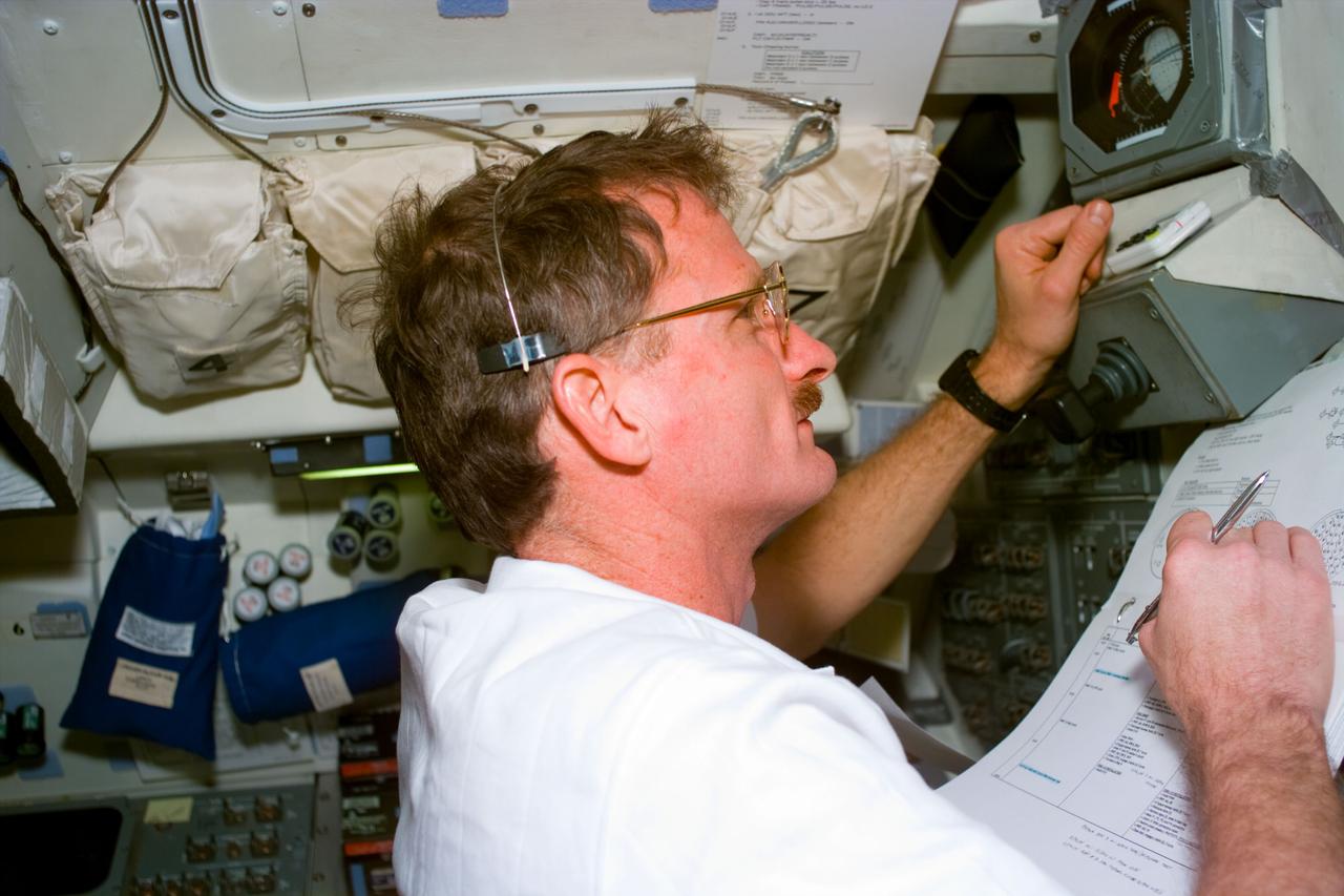 S82-E-5560 (16 Feb. 1997) --- On the Space Shuttle Discovery's aft flight deck, astronaut Joseph R. Tanner keeps up with the progress of his crew's third Extravehicular Activity (EVA) to service the Hubble Space Telescope (HST). Earlier, wearing an Extravehicular Mobility Unit (EMU), he participated in the second EVA, and he will join Gregory J. Harbaugh on the fourth tomorrow. This view was taken with an Electronic Still Camera (ESC).