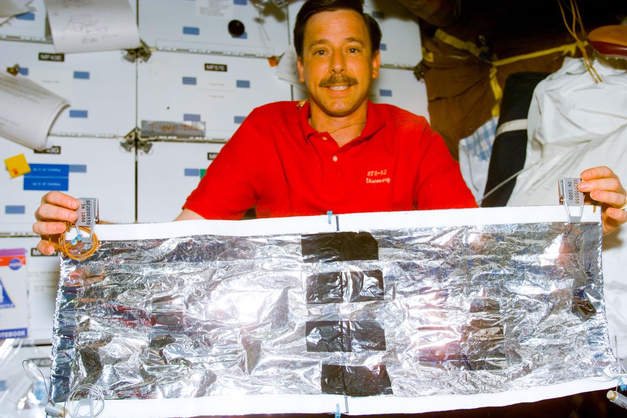 S82-E-5686 (17 Feb. 1997) --- Astronaut Scott J. Horowitz, STS-82 pilot, shows the hand-crafted thermal insulation blanket to support the goal of the final Extravehicular Activity (EVA) to cover tears in Hubble Space Telescope's (HST) insulation caused by changes in thermal conditions. This view was taken with an Electronic Still Camera (ESC).