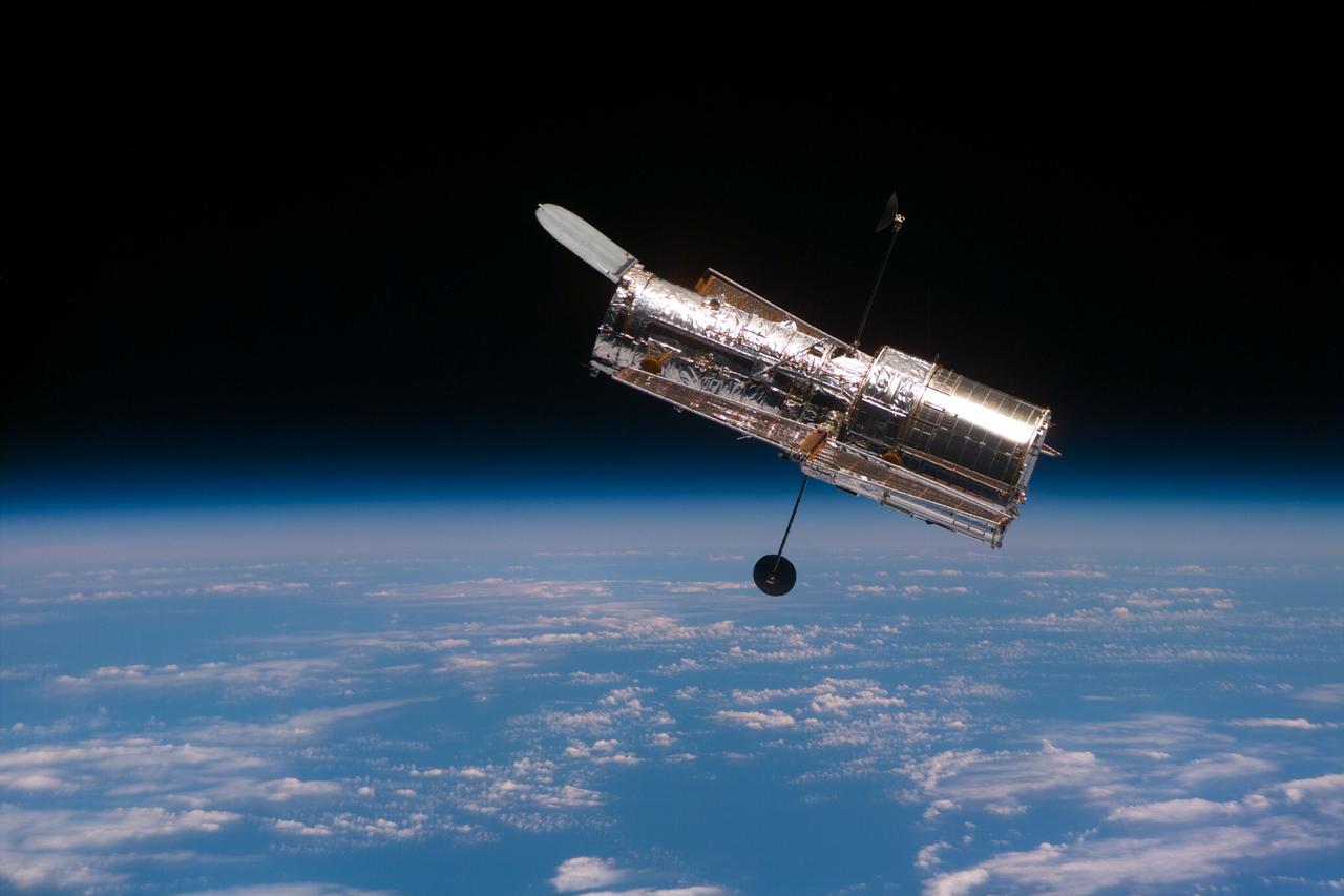 S82-E-5937 (11-21 Feb. 1997) --- The Hubble Space Telescope (HST) begins its separation from the Space Shuttle Discovery following its release. This view was taken with an Electronic Still Camera (ESC).