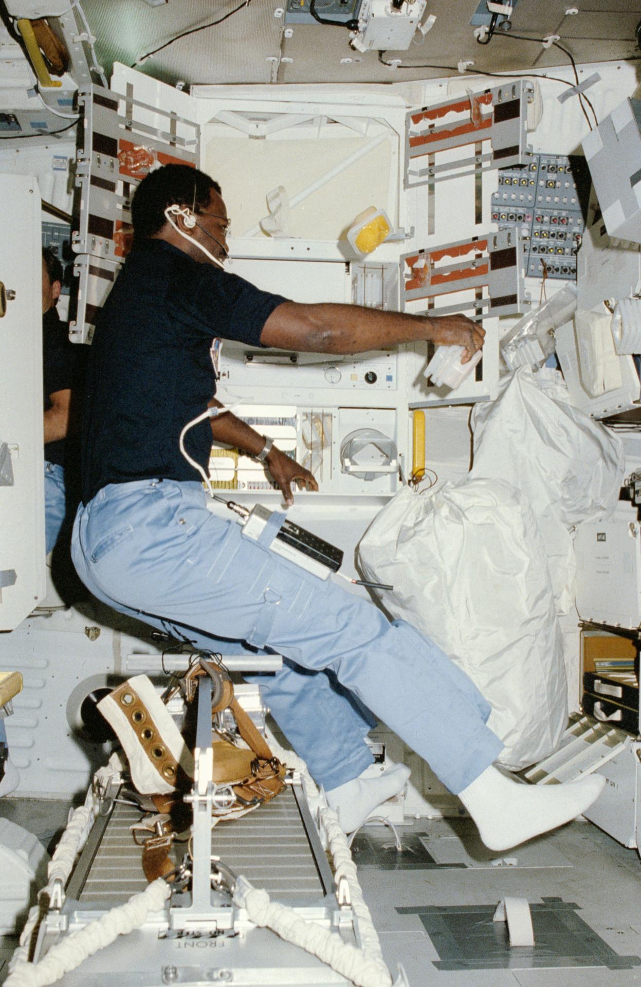 Astronaut Ron McNair prepares for a meal on board Space Shuttle Challenger