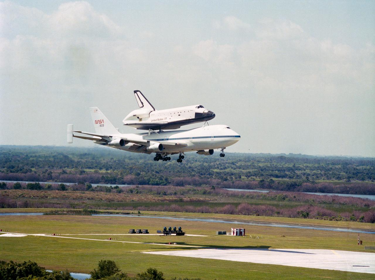 S84-33083 (18 April 1984) --- The Space Shuttle Challenger, atop NASA 905, approaches the runway at Kennedy Space Center following a flight from Edwards Air Force Base in southern California.  Less than two weeks earlier the Challenger, mated to two solid rocket boosters and an external fuel tank, launched into space from a nearby launch pad for a week-long stay in space.