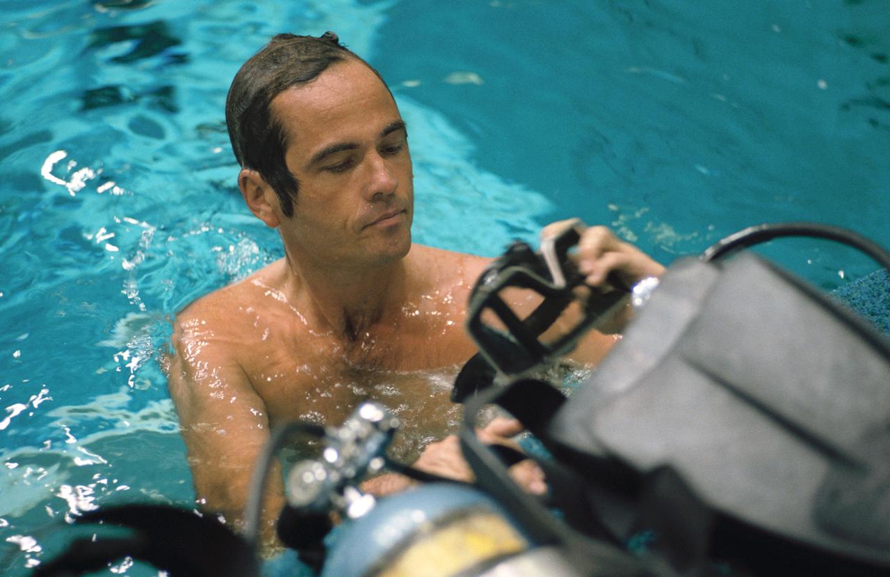 S84-36956 (1 July 1984) --- Astronaut Robert L. Crippen, 41-G crew commander, prepares his SCUBA mask prior to submerging into the weightless environment training facility's 25 ft. deep pool to observe a simulation exercise for two fellow 41-G crewmembers assigned to an extravehicular activity (EVA) in space.  Not pictured are Astronauts Kathryn D. Sullivan and David C. Leestma, mission specialists who will perform the EVA during the eight-day mission scheduled for October of this year.