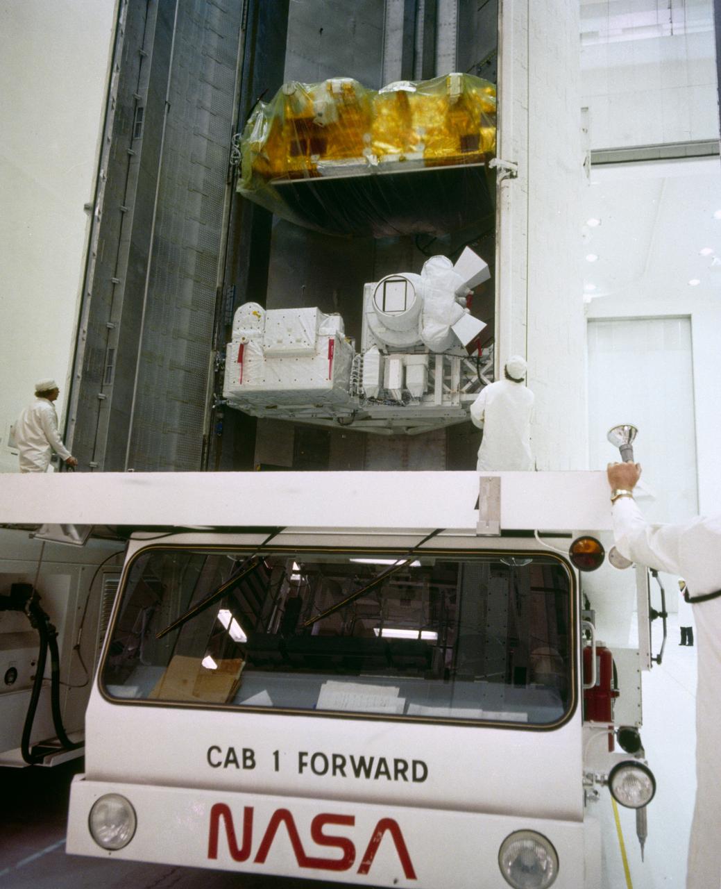 Payload canister transporter in Vertical Processing Facility Clean Room loaded with Earth Radiation Budget Experiment (ERBS), Large Format Camera (LFC), and Orbital Reservicing System (ORS) for STS-41G Mission.        1.  STS-41G - EXPERIMENTS    2.  CAMERAS - LFC       KSC, FL      Also available in 4x5 CN
