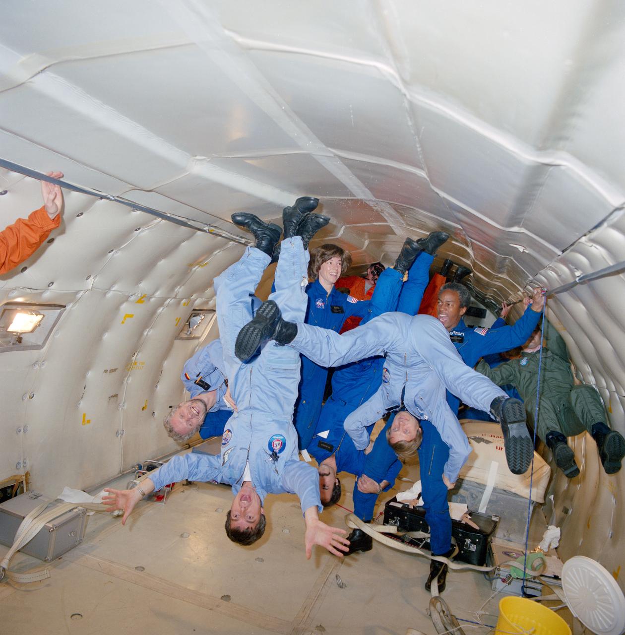 S84-47177 (17 Dec 1984) --- A recent flight in NASA's KC-135 aircraft gave the STS 61-A/Spacelab D-1 crewmembers a chance to get a preview of weightlessness.  Mission specialists Bonnie J. Dunbar and Guion S. Bluford appear to be balancing several payload specialists during a few brief moments of microgravity.  With heads near the floor are, left to right, Payload Specialists Reinhard Furrer, Ulf Merbold, Wubbo J. Ockels and Ernst Messerschmid.  Ockels is from the Netherlands; the others, from Germany, with Merbold serving as backup.