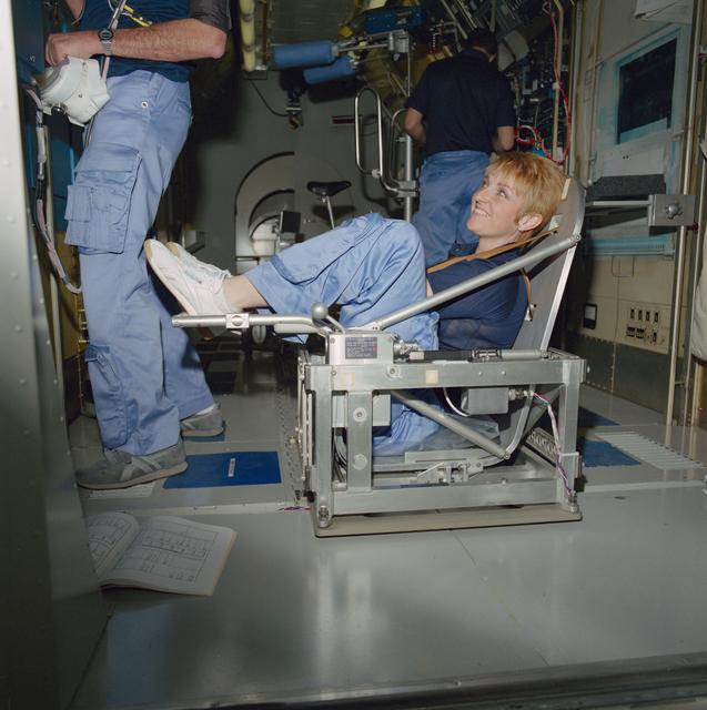 Payload specialists Millie Hughes-Fulford in Body Mass Measurement Device