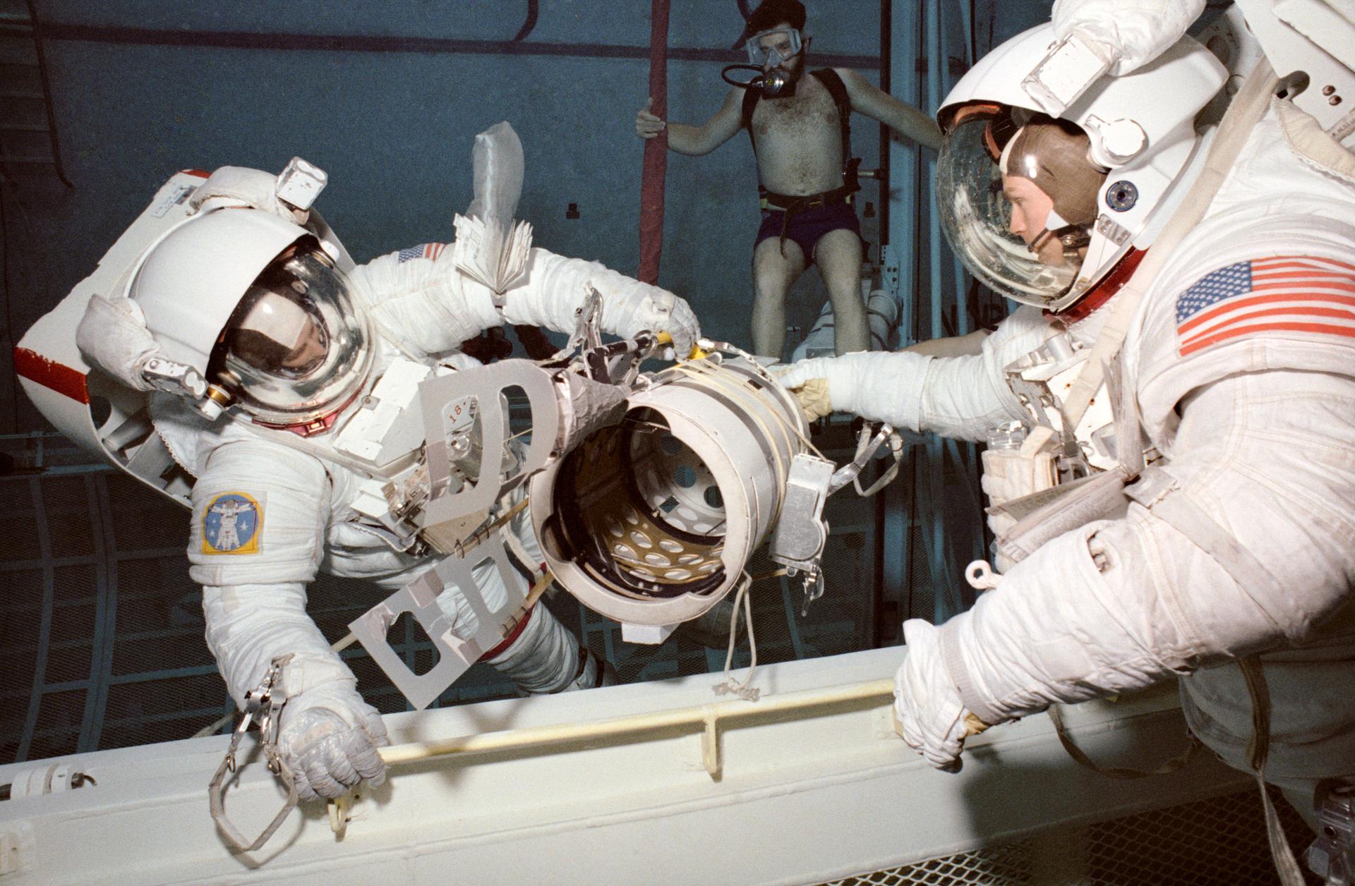 Astronauts Jerry Ross and Mark Lee practice for an EVA during an underwater training