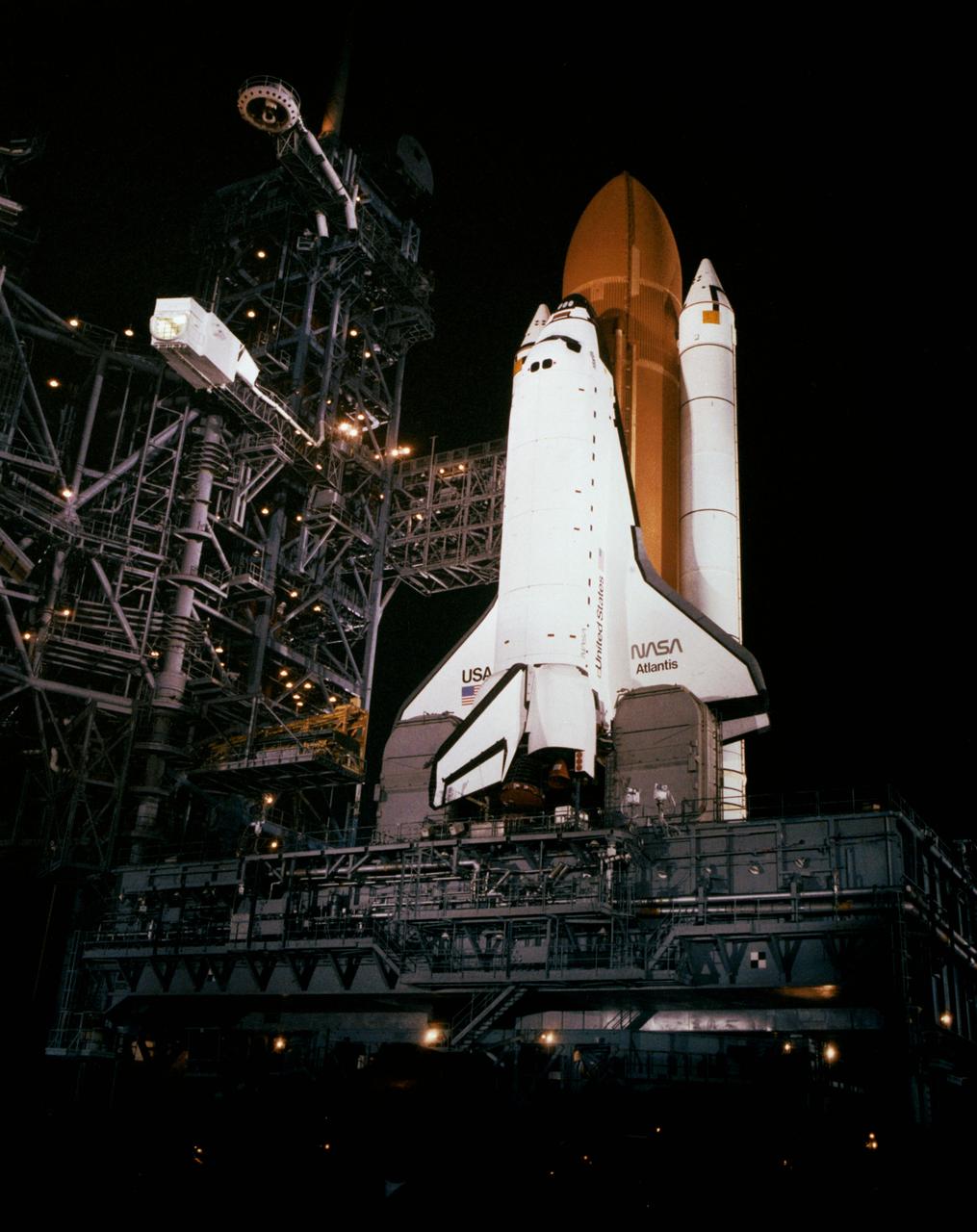 S85-40820 (11 Sept 1985) --- The Space Shuttle Atlantis, scheduled to fly in early October on its first space mission, designated STS-51J, is seen being readied for launch in this low-angle night scene at launch Complex 39, at the Kennedy Space Center (KSC).
