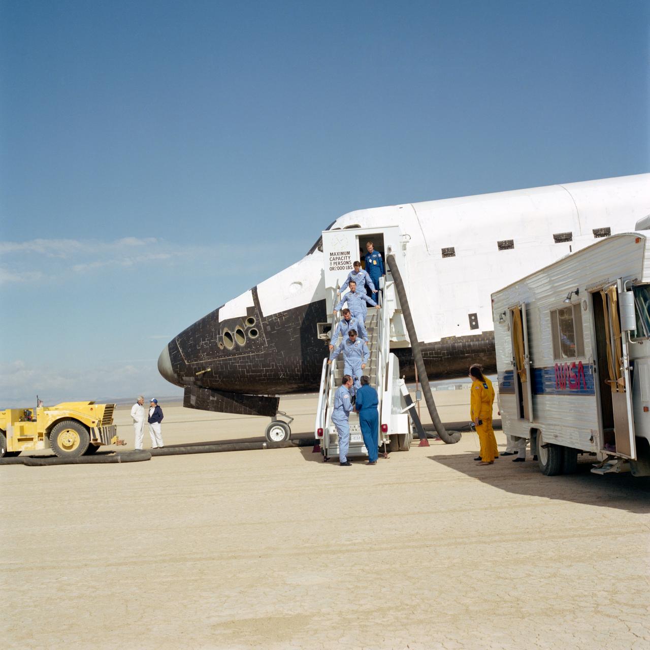 S85-41803 (7 Sept 1985) --- George W.S. Abbey, bottom right, greets the five members of the STS 51-J crew as they egress the Atlantis following the successful completion of a mission in Earth orbit.  Astronaut Karol J. Bobko, who led the five down the steps, shakes hands with the JSC director of flight crew operations.  He is followed (bottom to top) By Astronauts Ronald J. Grabe, pilot; David C. Hilmers and Robert L. Stewart, both mission specialists; and USAF Maj. William A. Pailes, payload specialist.