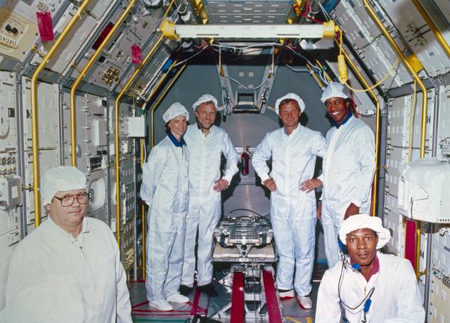 NASA image: Four STS 61-A crewmembers  with vestibular sled experiment