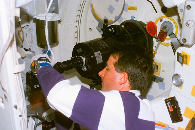 NASA image: SWUIS - Robinson works with telescope mounted in the side hatch window