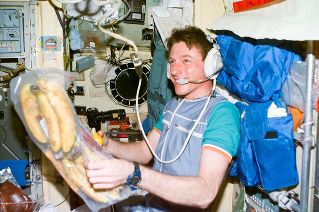 NASA image: Foale examines fresh fruit brought to Mir by the STS-86 crew