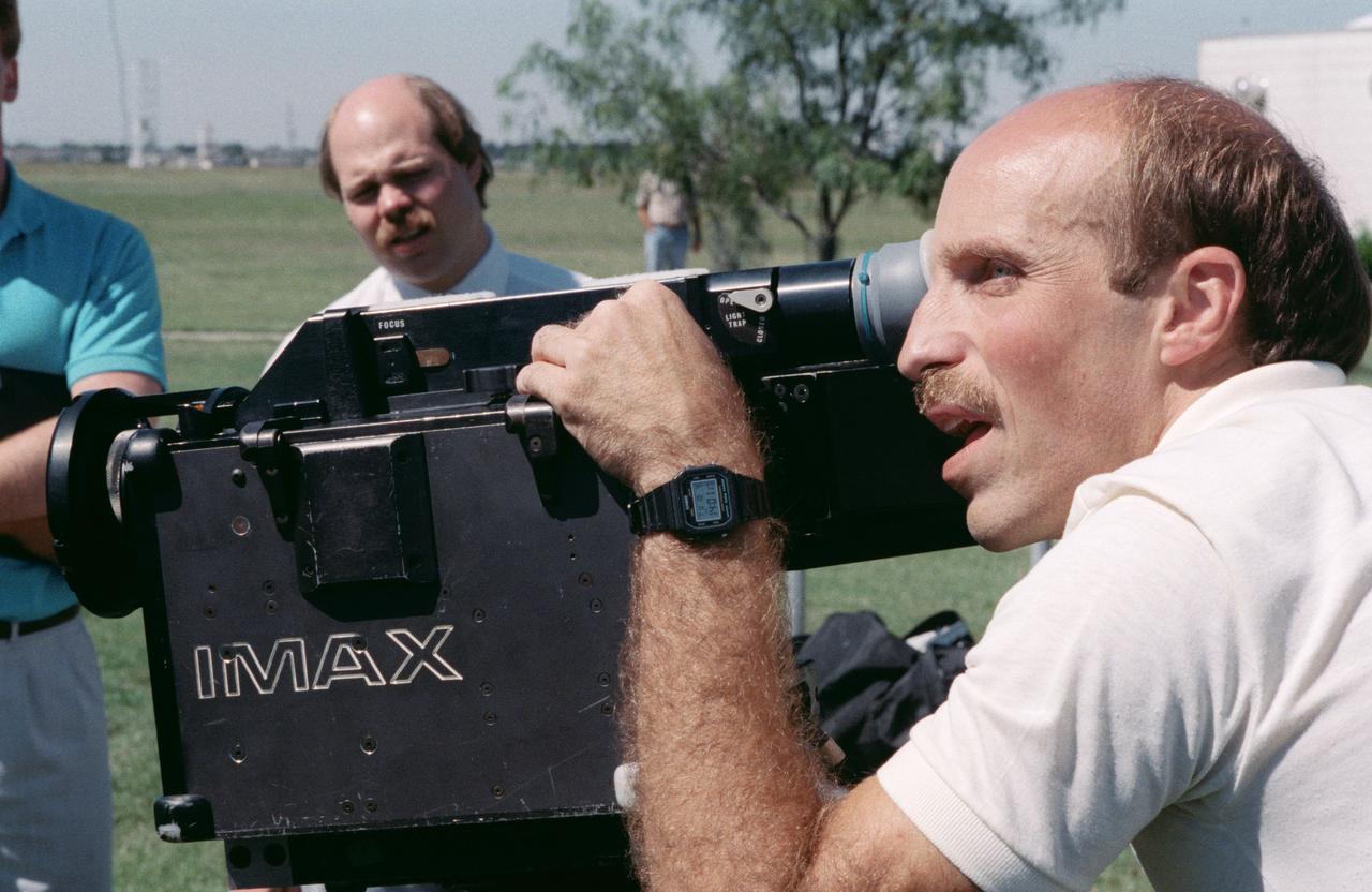 S88-52466 (8 Nov 1988) --- James P. Bagian, STS-29 mission specialist, gets in some training on the operation of one of the payloads for his upcoming spaceflight aboard Discovery.  The crew met with Imax personnel, some of whom are pictured here, on the JSC grounds to practice using the motion-  picture camera, making its first post-Challenger trip into space.  The payload flew on a number of earlier STS flights.