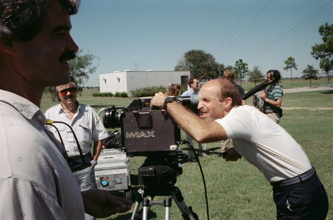 S88-52470 (8 Nov 1988) --- James P. Bagian, STS-29 mission specialist, gets in some training on the operation of one of the payloads for his upcoming spaceflight aboard Discovery.  The crew met with Imax personnel, some of whom are pictured here, on the JSC grounds to practice using the motion-  picture camera, making its first post-Challenger trip into space.  The payload flew on a number of earlier STS flights.