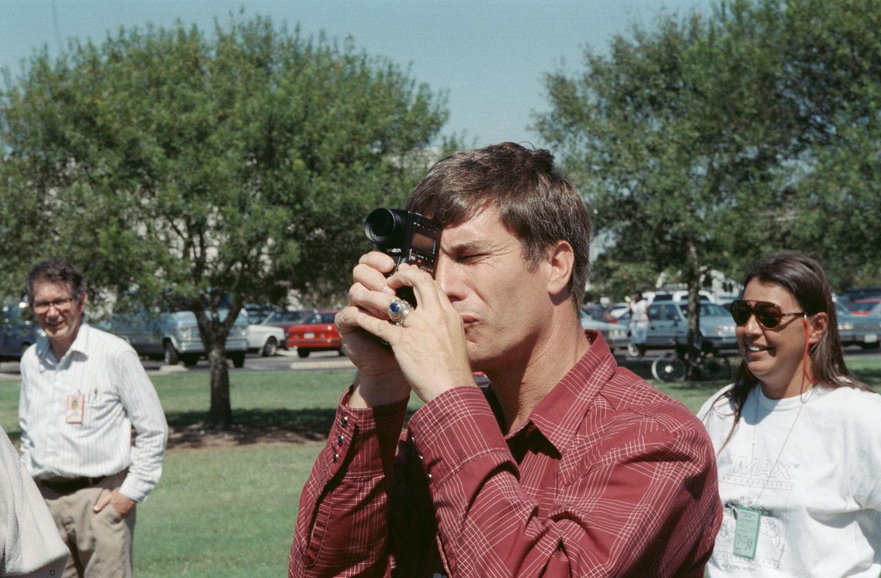 S88-52476 (8 Nov 1988) --- John E. Blaha, STS-29 pilot, gets in some training on the operation of one of the payloads for his upcoming spaceflight aboard Discovery. The payload is an Imax motion-picture camera, hardware of which is out of frame here.  Blaha uses a light meter to get a reading before   operating the camera in a practice run.  The crew met with Imax personnel on the JSC grounds to practice using the motion-picture camera, making its first post-Challenger trip into space. Phyllis Wilson with Imax is at far right.  The payload flew on a number of earlier STS flights.