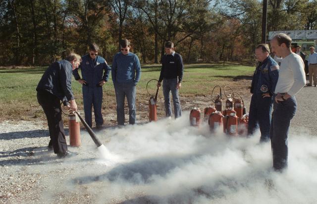 NASA image: Fire/security staff member instructs STS-29 crew on fire extinguisher usage