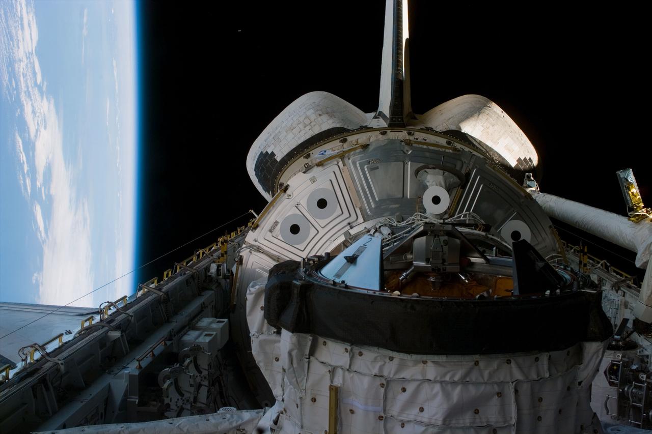 S88-E-5009 (12-04-98) ---  This medium closeup electronic still camera (ESC) photograph shows Endeavour's docking system in the cargo bay. Though partially obscured, Unity can be seen in its stowed position in aft payload pay. The photo was taken prior to astronaut Nancy Currie's moving of the 12.8-ton Unity connecting module to link it with Endeavour's docking system.  The photo was taken at 21:28:19 GMT, Dec. 4, and downlinked later to flight controllers in Houston.