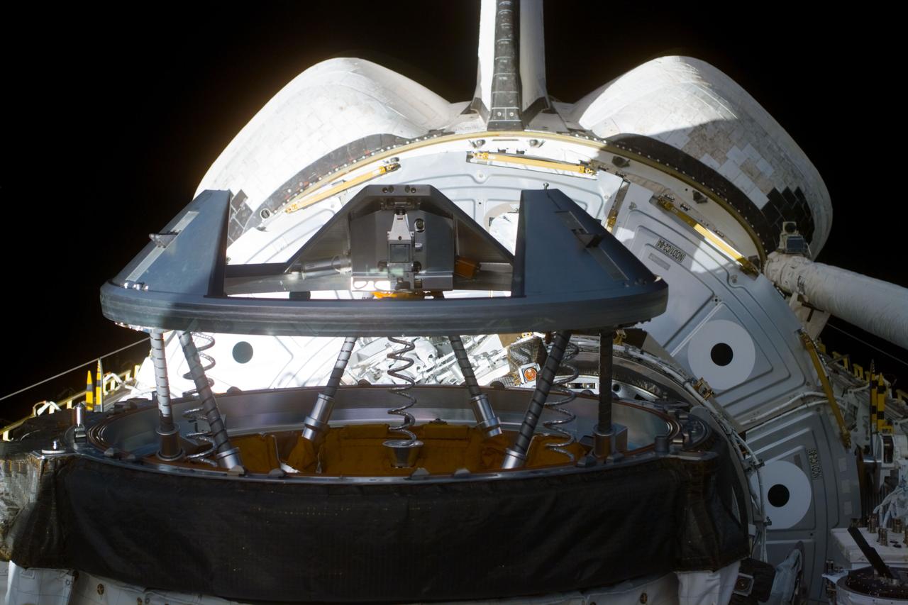 S88-E-5018 (12-05-98) ---  This medium closeup electronic still camera (ESC) photograph shows Endeavour's docking system in the cargo bay. Though partially obscured, Unity can be seen in its stowed position in aft payload pay. The arm of the remote manipulator system (RMS) is seen in its berthed  position on the right. The photo was taken prior to astronaut Nancy Currie's moving of the 12.8-ton Unity connecting module to link it with Endeavour's docking system.  The photo was taken at 09:35:57 GMT, Dec. 5, and downlinked later to flight controllers in Houston.