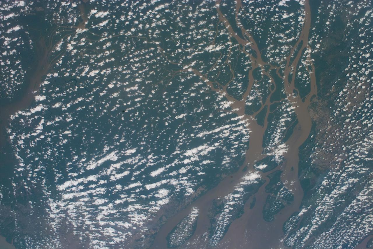 S88-E-5028 (12-05-98) --- Partial cloud cover above the mouth of the Amazon was captured with an electronic still camera by the astronauts aboard the Space Shuttle Endeavour.  The image was recorded at 16:41:42 GMT, Dec. 5.