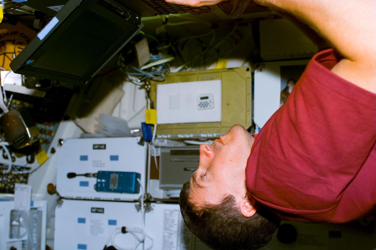 S88-E-5041 (12-06-98) --- Sergei Krikalev, mission specialist representing the Russian Space Agency (RSA), works on a laptop computer on Endeavour's middeck.  The scene was photographed shortly after the successful mating of Unity with the shuttle's docking system.