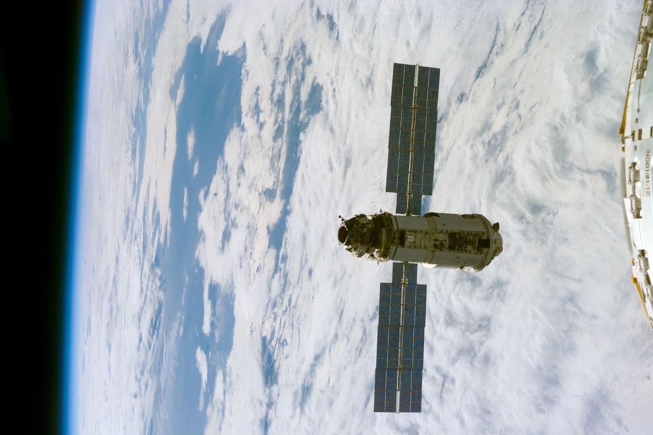 S88-E-5046 (12-06-98) --- With Endeavour's astronauts waiting to mate the Russian-built Zarya control module with the U.S.-built Unity connecting module, an electronic still camera (ESC) was used to record this image of the approaching Zarya, backdropped over a blue and white Earth. A small part of Unity can be seen (in uncropped versions of the photo) at right. Using the shuttle's 50-ft.-long Canadian-built robot arm, astronaut Nancy J. Currie, working from Endeavour's aft flight deck, plucked Zarya out of orbit at 5:47 p.m. (CST), Dec. 6. The craft had been orbiting Earth for a little over 16 days prior to the grapple and subsequent docking to Unity. This image was recorded at 23:06:12 GMT, Dec. 6.