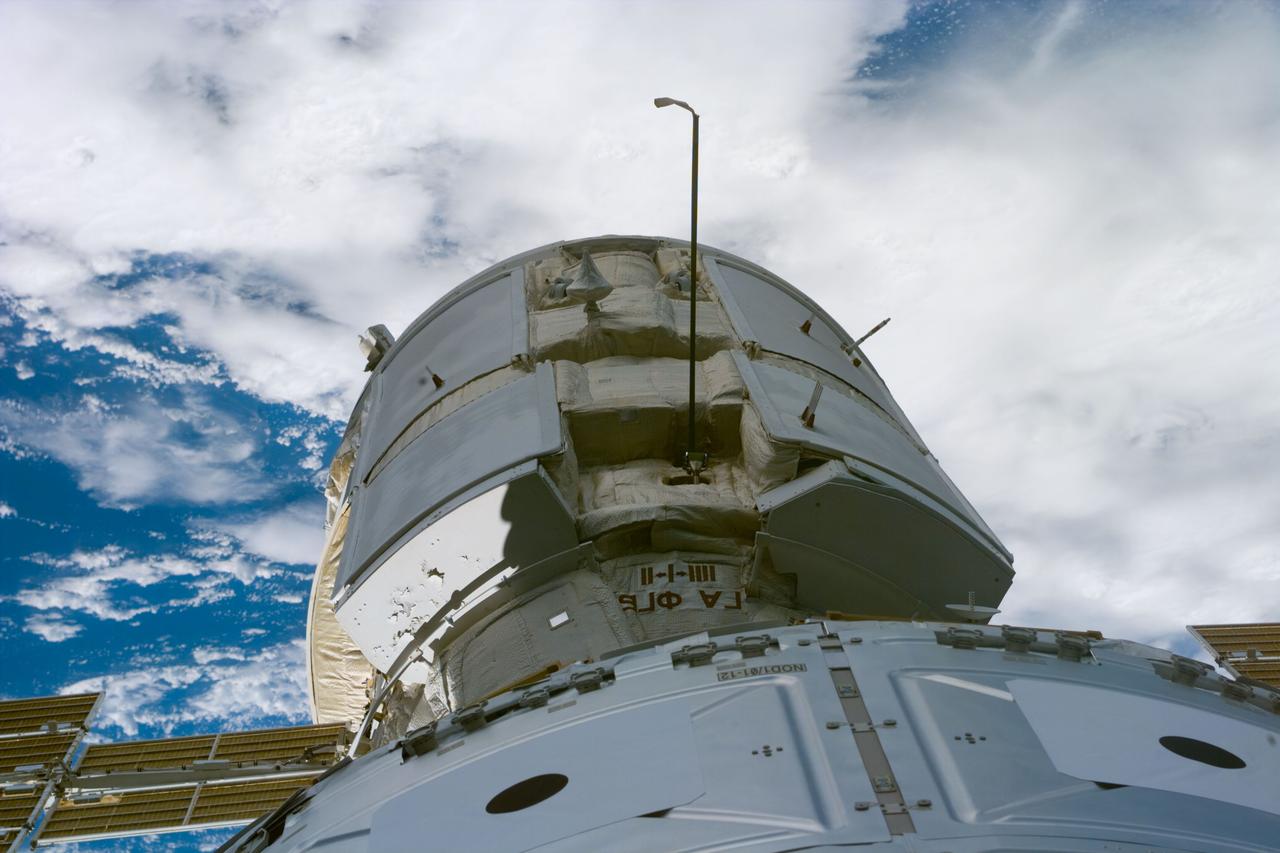 S88-E-5049 (12-07-98) --- Just a few feet away from the camera lens onboard Endeavour, the Russian-built Zarya control module and the U.S.-built Unity connecting module are mated in the shuttle's cargo bay. Using the Endeavour's 50-ft.-long Canadian-built robot arm, astronaut Nancy J. Currie, working from the aft flight deck, plucked Zarya out of orbit at 5:47 p.m. (CST), Dec. 6. The craft had been orbiting Earth for a little over 16 days prior to the grapple and subsequent docking to Unity. This image was recorded with an electronic still camera (ESC) at 00:22:48 GMT, Dec. 7.