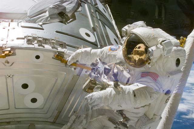 NASA image: Astronaut Newman holds onto handrail 0133 on panel NOD1/C2-07