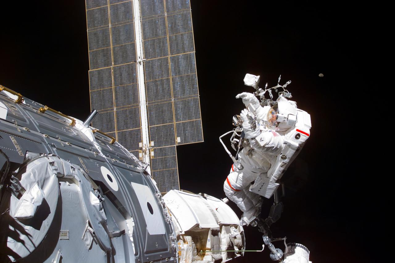 S88-E-5058 (12-08-98) --- Astronaut Jerry L. Ross takes a picture during a 7-hour, 21 minute spacewalk. Astronauts Ross and James H. Newman went on to mate 40 cables and connectors runing 76 feet from the Zarya control module to Unity, with the 35-ton complex towering over Endeavour's cargo bay. The photo was taken with an electronic still camera (ESC) at 00:35:05 GMT, Dec. 8.