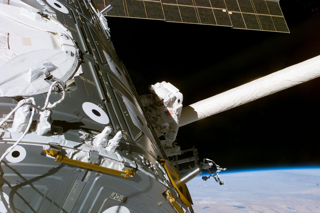 S88-E-5060 (12-08-98) --- Astronaut James H. Newman is seen near the Unity module during late phases of the first of three scheduled spacewalks on STS-88. At the end of the extravehicular activity (EVA), astronauts Newman and Jerry L. Ross, both mission specialists, were  successful in mating 40 cables and connectors running 76 feet from the Zarya control module to Unity, with the 35-ton complex towering over Endeavour's cargo bay. The spacewalk last 7 hours and 21 minutes. This photo was taken with an electronic still camera (ESC) at 03:50:28 GMT, Dec. 8.