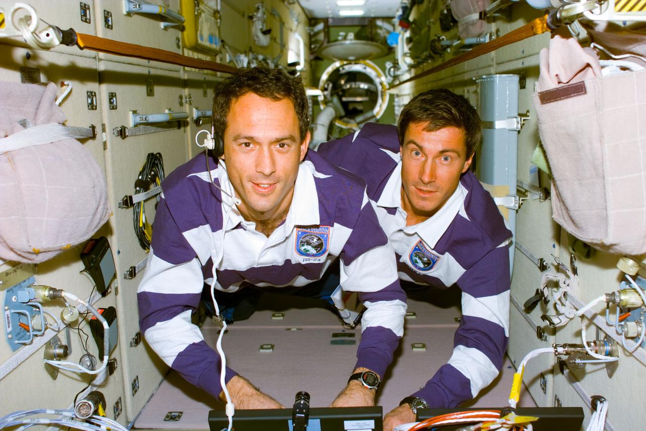 S88-E-5081 (12-11-98) --- James H. Newman (left) and Sergei Krikalev are in communications with ground controllers while working aboard Zarya.  The two are mission specialists, with Krikalev representing the Russian Space Agency (RSA).  The photo was taken with an electronic still camera (ESC) at  05:23:01 GMT, Dec. 11.