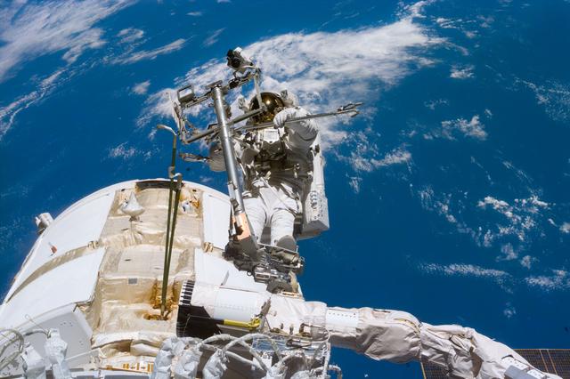 NASA image: Newman on RMS arm after deploying TORU antenna on FGB/Zarya module