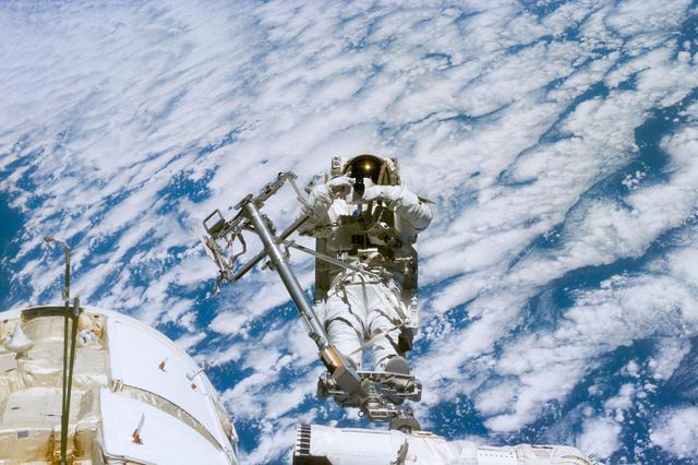 NASA image: Newman on RMS arm after deploying TORU antenna on FGB/Zarya module
