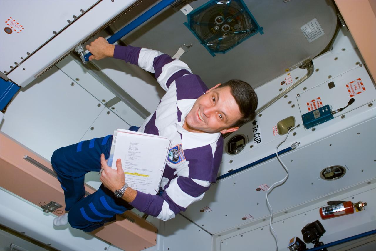 S88-E-5111 (12-10-98) --- Astronaut Robert D. Cabana, mission commander, totes a notebook while checking on the progress of readiness tasks onboard the Unity connecting module.  The photo was taken with an electronic still camera (ESC) at 20:25:57 GMT, Dec. 10.